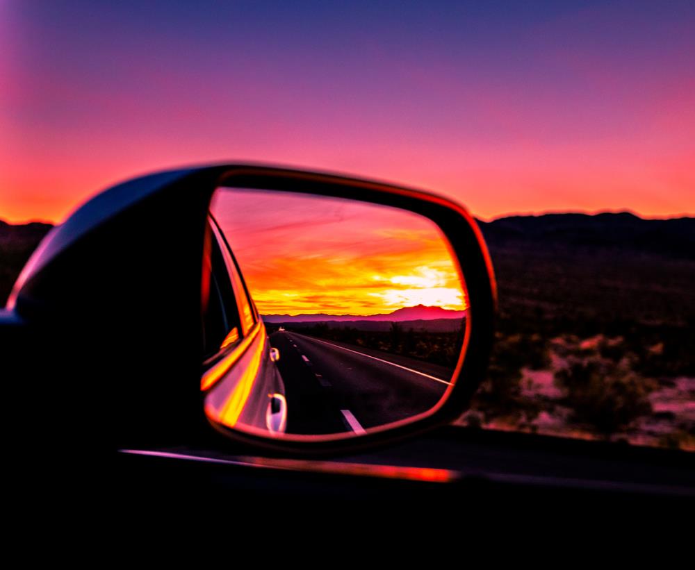 car side mirror with sunset in reflection